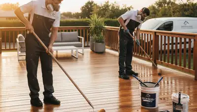 Pittsburgh Paint Pros sealing a wood deck to protect against rain, snow, and humidity in Pittsburgh, PA